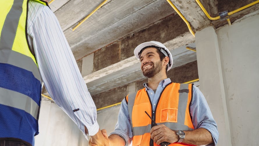 Handsome,Construction,Workers,In,Protective,Helmets,And,Reflective,Vests,Are