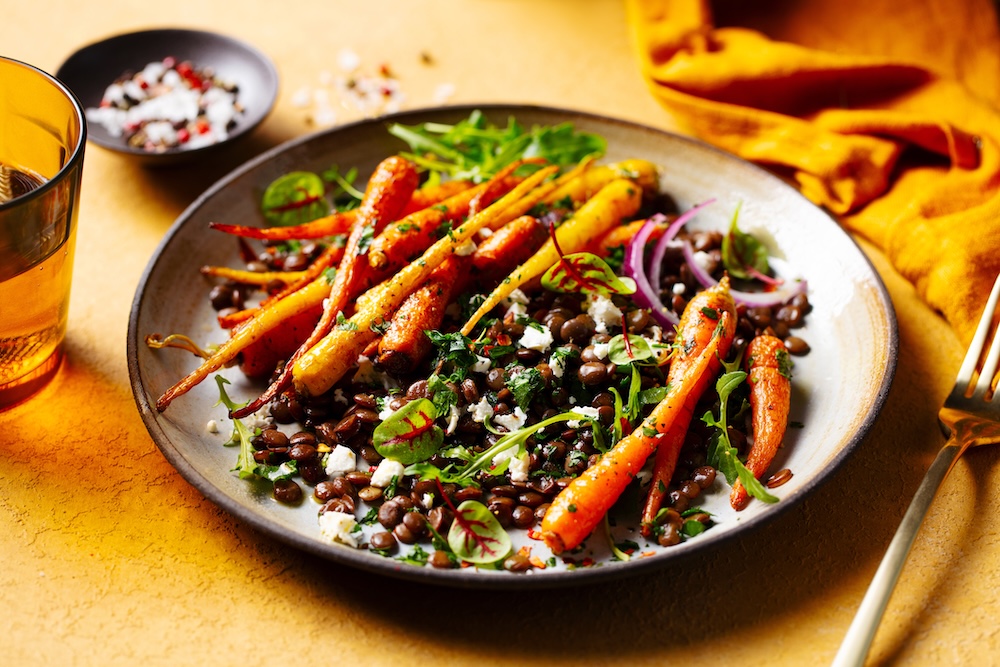 Salade de lentilles avec carottes rôties, oignons rouges, herbes fraîches et fromage émietté